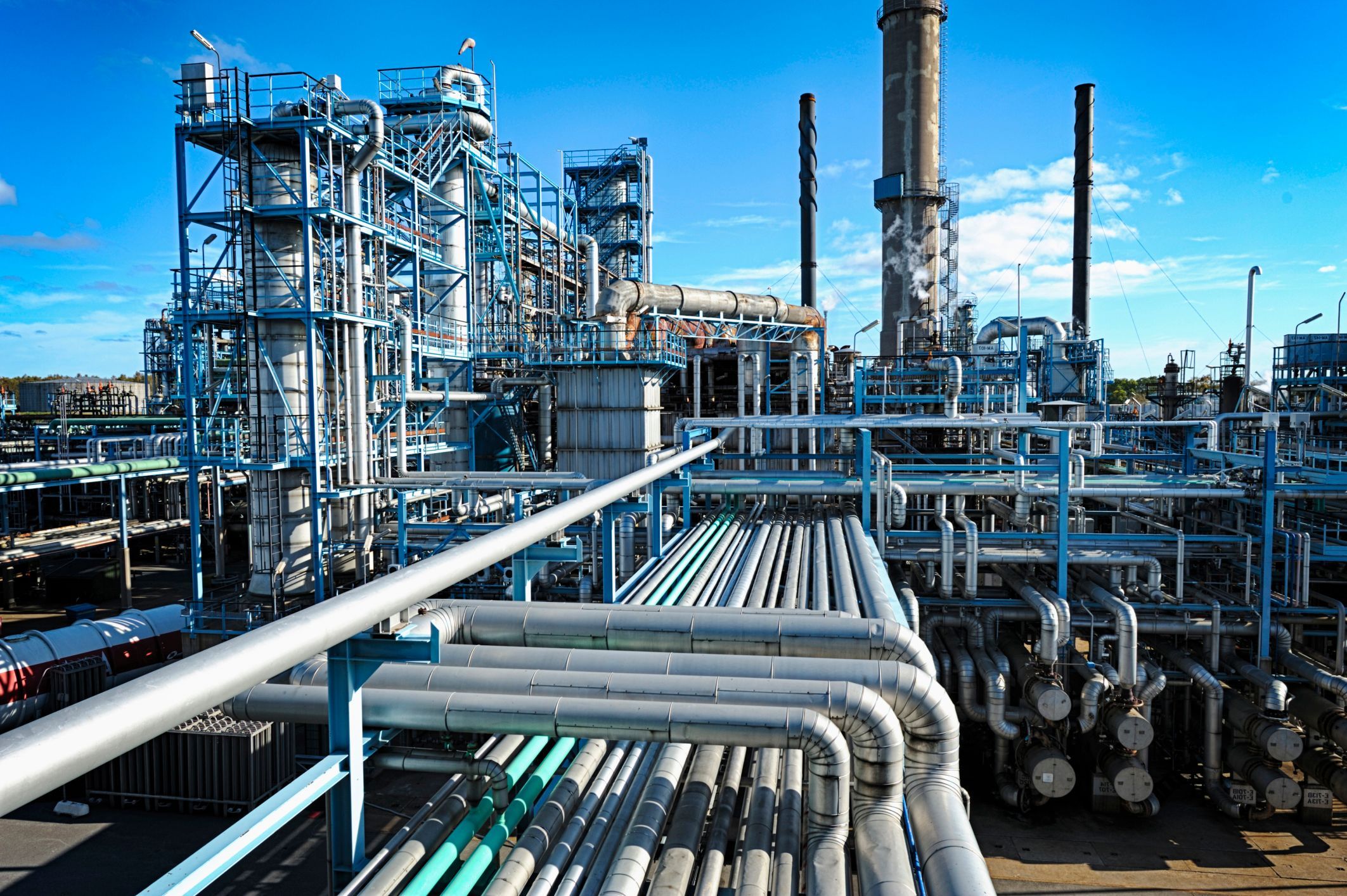 photograph of an oil refinery with pipes